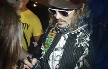 Johnny Depp signing autographs in his U-jack scarf